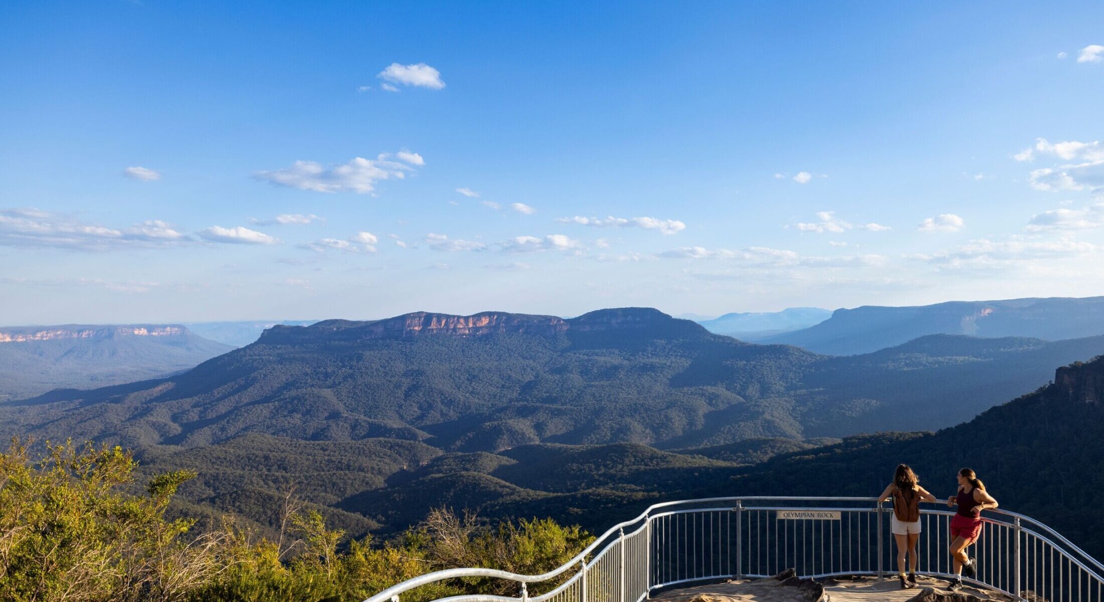 Hikers enjoy the view at the Olympian Rock Lookout, Blue Mountains.