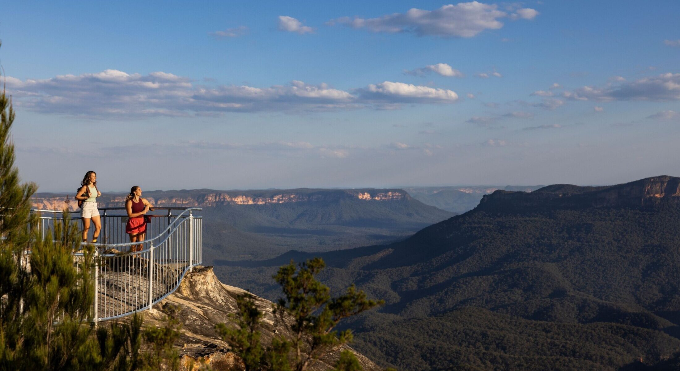 Hikers enjoy the view at the Olympian Rock Lookout, Blue Mountains.