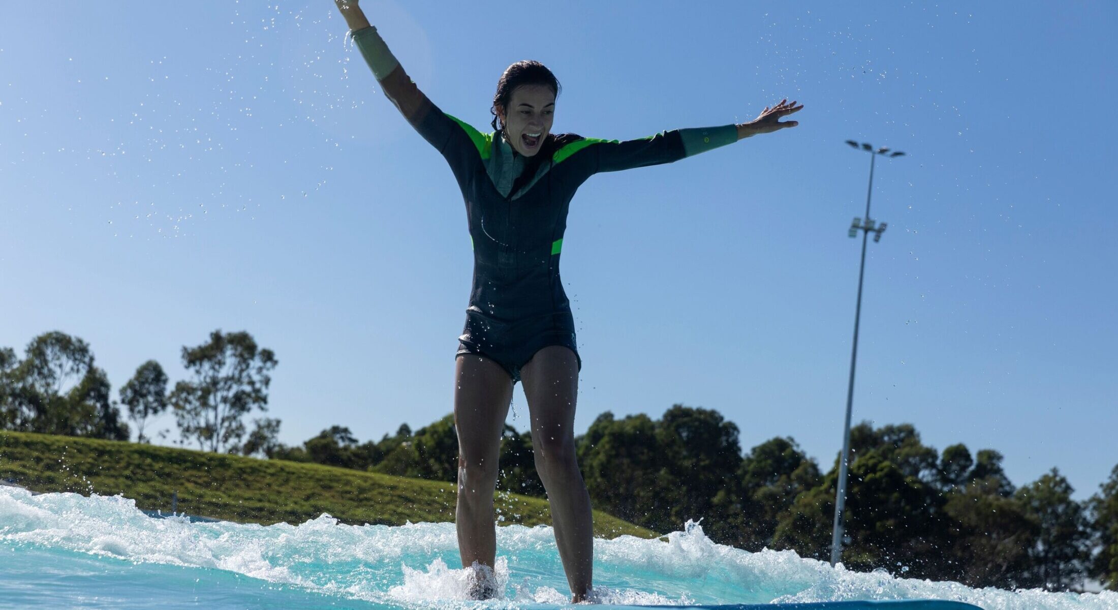 Woman enjoys the surf at Australia's best urban surfpark, URBNSURF, Homebush